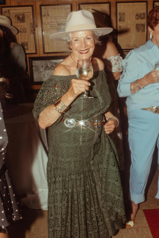 Elderly lady holding wine glass